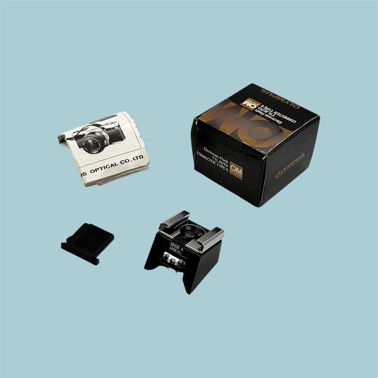 Griffe-flash Olympus Shoe n°4, boîte, notice & protection